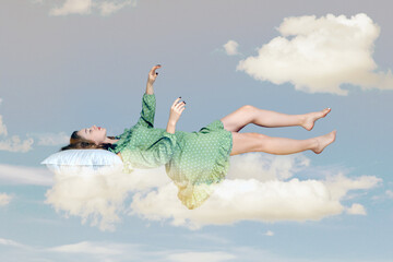 Sleeping beauty floating in air. Relaxed girl in vintage ruffle dress keeping eye closed, lying on...