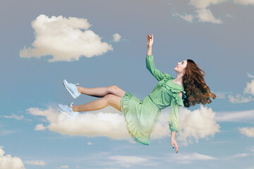 Hovering in air. Cheerful smiling pretty girl in ruffle dress levitating flying in mid-air, looking...