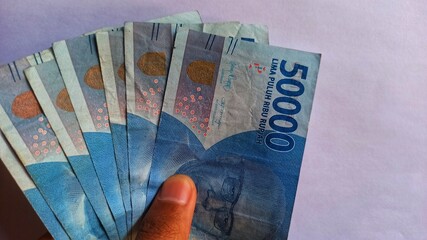 A collection of fifty thousand rupiah from salary, savings, and buying - obrazy, fototapety, plakaty