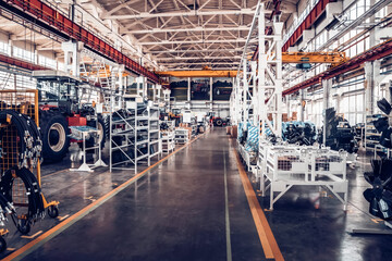 Fototapeta premium Assembly workshop at big industrial plant. Tractor assembling