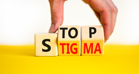 Stop stigma symbol. Concept words Stop stigma on wooden cubes. Businessman hand. Beautiful yellow table white background. Business and Stop stigma concept. Copy space.
