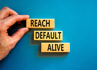 Reach default alive symbol. Concept words Reach default alive on wooden blocks on a beautiful blue table blue background. Businessman hand. Business, finacial and reach default alive concept.