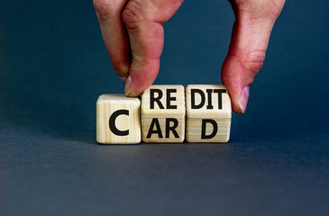 Credit card symbol. Concept words Credit card on wooden cubes. Businessman hand. Beautiful grey table grey background. Credit card and business concept. Copy space.