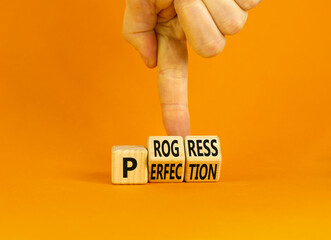 Progress or perfection symbol. Concept words Progress or Perfection on wooden cubes. Businessman hand. Beautiful orange table orange background. Business progress or perfection concept. Copy space.