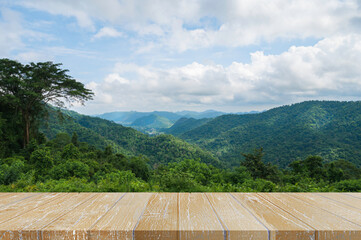 Wooden table with beautiful landscape of mountains layer nature background.