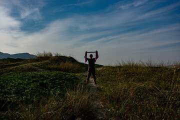 silhouette of a person in a field, Florianópolis, Brasil