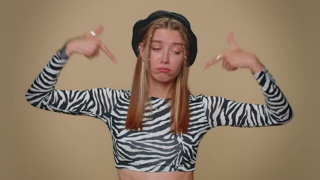 I am the best. Proud egoistic lovely pretty young woman proud of her victory, bragging own success win achievements, pointing fingers on herself with smile. Adult stylish girl on beige background