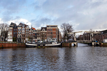 Typical Amsterdam cityscape. Amsterdam canals, boats and dutch architecture, Netherlands