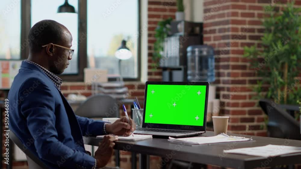 Poster businessman working with greenscreen display on laptop, planning project with blank chroma key templ