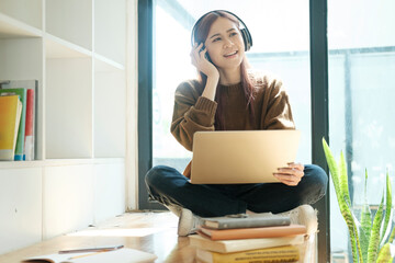 Young women study in front of the laptop computer at home.