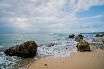 Fototapeta na wymiar rocks, coastline, sea and sky at padang padang beach in bali indonesia