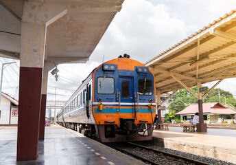 The train come to railway station platform.