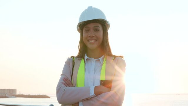 Happy, construction professional female worker on site. Closeup of happy, confident, independent contractor beginning a new foundation on site. Woman smiling from a job well done.
