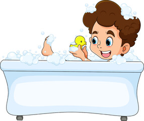 The happy boy is taking a bath in the bathtub and playing the duck rubber