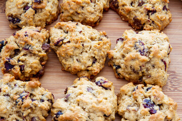 Freshly baked cranberry scones; delicious golden cranberry scones cooling on a wood cutting board