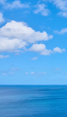 Copy space at the sea with a cloudy blue sky background above the horizon. Panoramic of calm ocean waters across a beach shore. Peaceful scenic coastal landscape for a relaxing and zen summer getaway