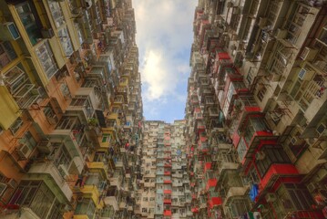 Low angle view of crowded residential towers in an old community in Quarry Bay, Hong Kong ~ Scenery of overcrowded narrow apartments, a phenomenon of high housing density & housing blues in HK