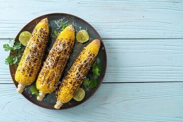 barbecue and grilled corn with cheese and lime