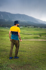 Traveler enjoying beauty scenery in Gulmarg valley during hot day in Jammu and Kashmir, India.