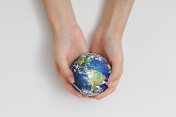 Human hand holding earth. Protect the environment to save the world concept. Elements of this image furnished by NASA.