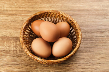 Raw organic farm eggs. Served in basket, copy space. 
