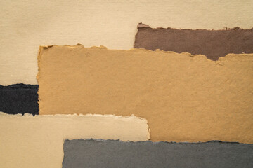 collection of handmade Indian paper with rough edges in earth tones tones produced from recycled cotton fabric