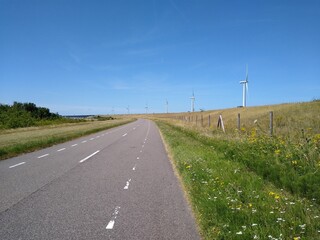 Fototapeta na wymiar Road with windmills