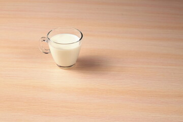 Glass of Milk on a Wooden Background. Diet Concept. Top Angle View.