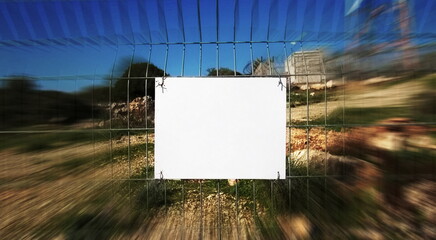 A piece of paper on the fence. Clean white blank billboard on the fence. Ad on the Fencing.