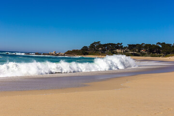 A view on Pacific ocean coast with blue sky and water and waves