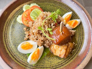 Thai food : spicy shrimp paste fried rice with stewed pork and boiled egg. Selective focus, top view