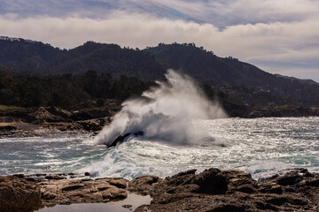 A view on Pacific ocean coast with blue sky and water and waves
