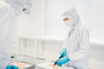 食品加工の仕事をする作業員の男女（精肉・食品工場）
