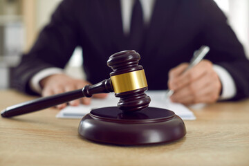 Close-up judge wooden gavel symbolizing legal proceedings or lawsuit from private person or...