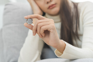 Stressed asian young couple, sad woman quarrel on couch, relationship in trouble. Wife's hand...