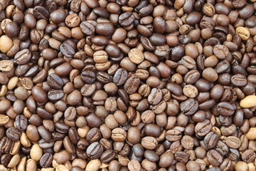 Roasted coffee beans background. Beverage concept for wallpaper, backdrop and texture.