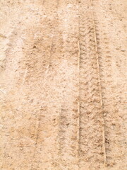 Wheel track of car on dry and cracked soil road