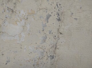 Wall fragment with scratches and cracks.vintage dirty exfoliating plaster Textured background peeling of colour wallpaper cement.The​ pattern​ of​ surface​ wall​ concrete​ for​ background.