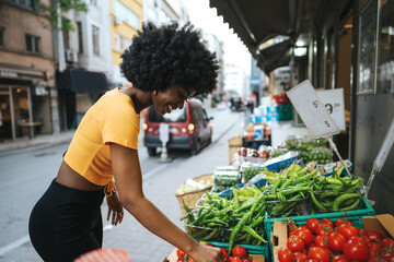 Young African American woman shopping at a local street market