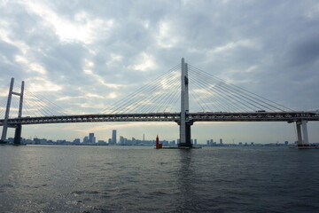 View of bridge against cloudy sky. Impressive Yokohama bay bridge over Tokyo Bay