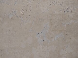 Abstract paint is peeling off the building wall.Close-up. Badly fixed building facade wall covered with cracks in stucco and paint. Missing patch of paint in the middle; crack with flappy.