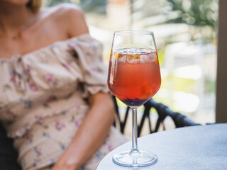 a woman and colorful cocktail