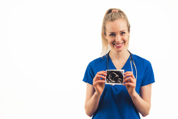 A smiling caucasian nurse showing a photo of an embryo - closeup. High quality photo
