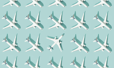 Creative composition made with passenger plane on blue background. Summer travel or vacation pattern.