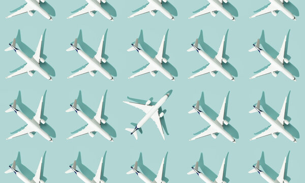 Creative composition made with passenger plane on blue background. Summer travel or vacation pattern.