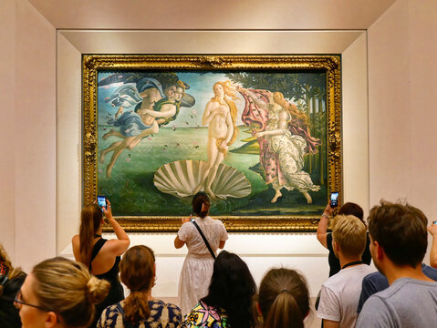 Florence, Italy - July 2022: Tourists taking photos in front of The Birth of Venus painting of Sandro Botticelli in Uffizi Gallery Museum in Florence Italy