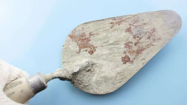 The old trowel is dirty. Old-fashioned bricklayer's trowel. The concept of building a house. Bricklayer concept.