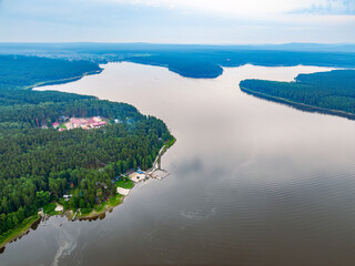 Big lake with green shores in bright sun light, aerial landscape. Recreation concept. Aerial view