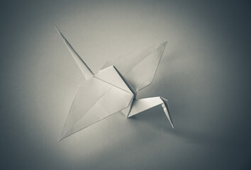 Fototapeta na wymiar White paper crane origami isolated on blank background