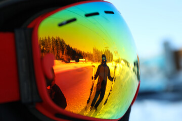 Reflection of skier in goggles, close up
